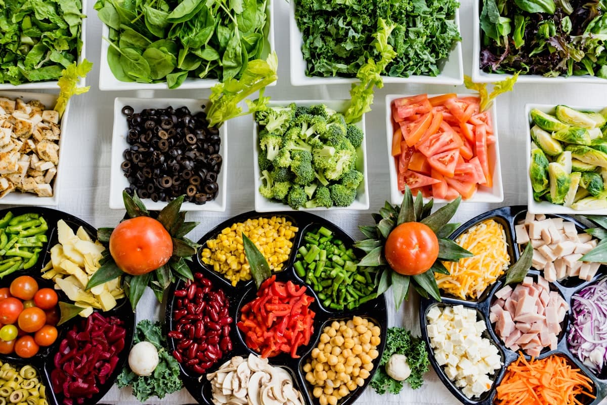 Chef assembling gourmet lunch boxes with fresh ingredients